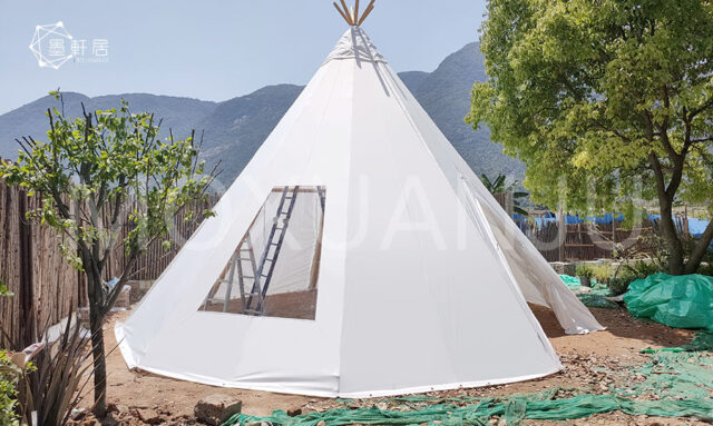 White teepee tent on green