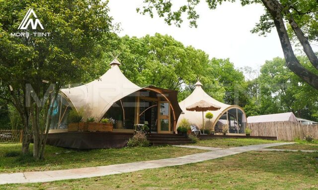 Outdoor glamping site featuring Canvas Safari Tent on a grassy plain