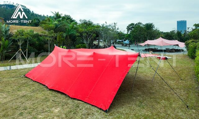 Red stretch tent on grass