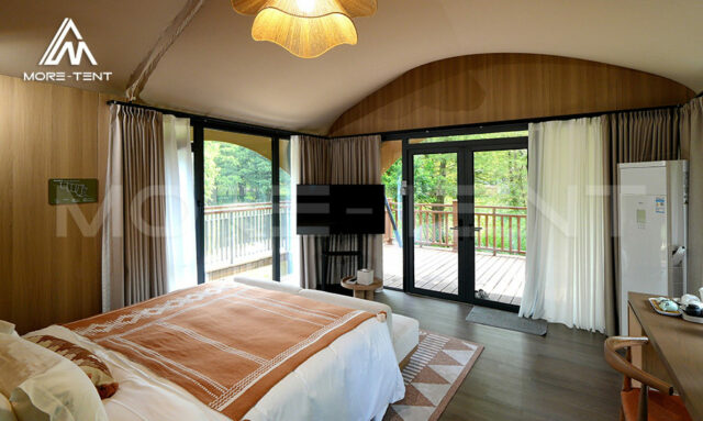Column free glamping tent interior with panoramic French windows