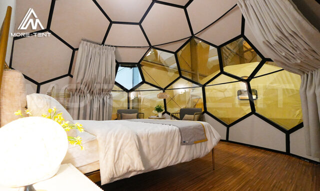 Winter glamping glass dome providing cozy and romantic accommodation