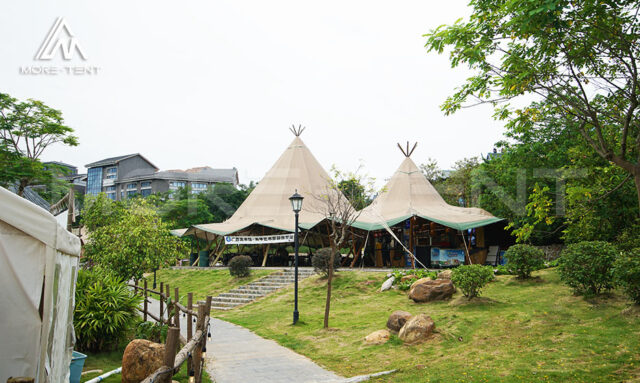Glamping tipi tents set in a landscaped garden resort with stone pathway