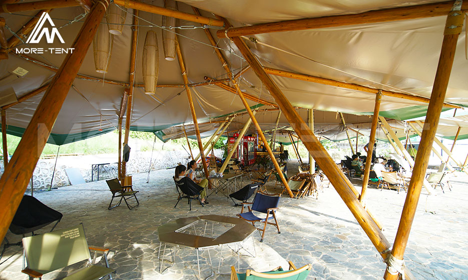 Tipi tent materials showing spruce wood pole frame and canvas roof cover interior
