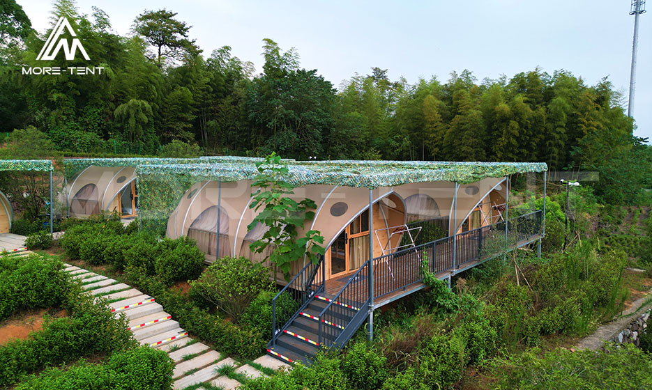 Glamping tent rooms with raised decks in a bamboo rural resort