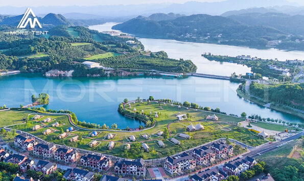 Aerial view of a lakeside glamping resort with MORE TENT tents