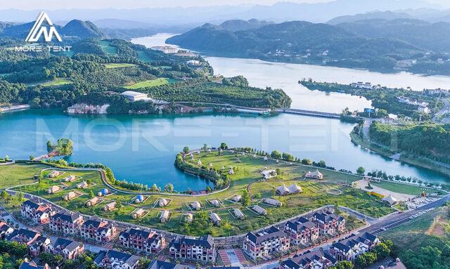 Aerial view of a lakeside glamping resort with MORE TENT tents