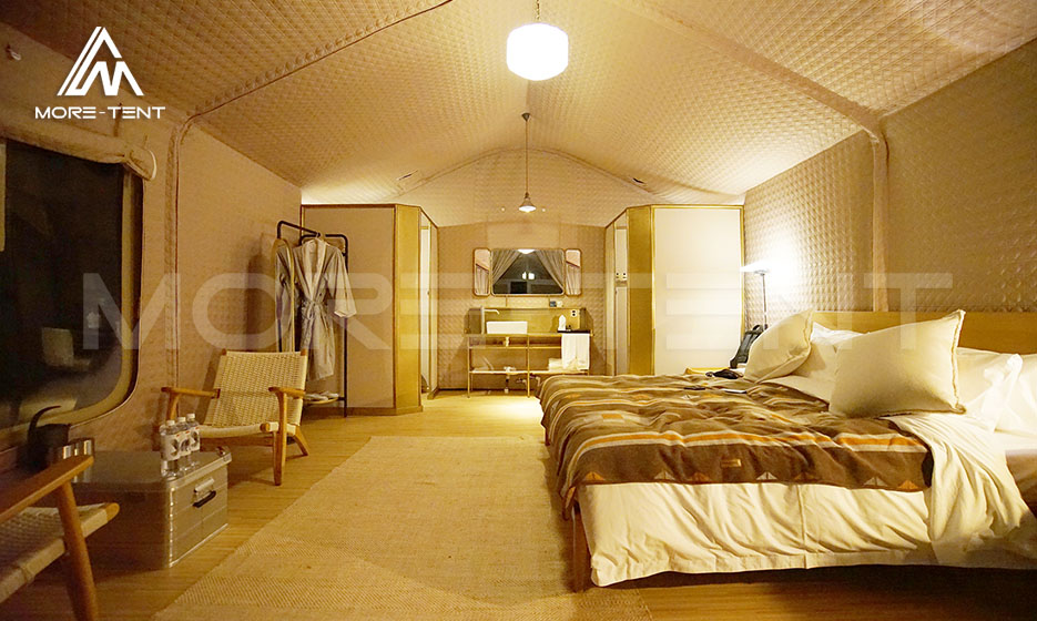 Luxury glamping tent bedroom interior with bed and private facilities