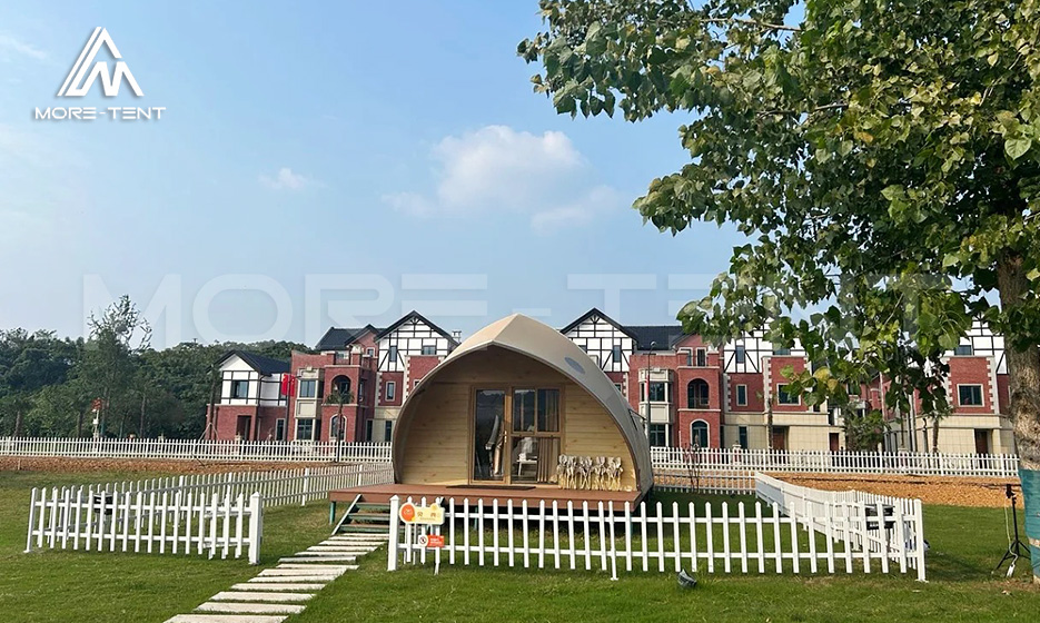 Shell shape glamping tent with a streamlined exterior on a lawn