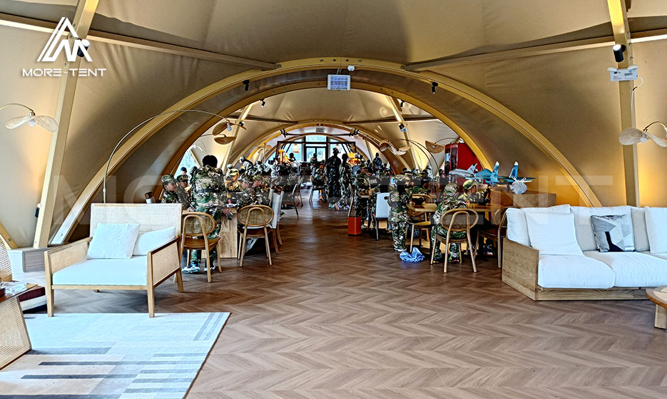 Spacious glamping tent hosting student group activities at a summer camp