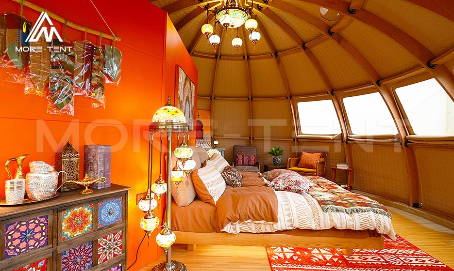 Decorated dome glamping tent bedroom with panoramic windows