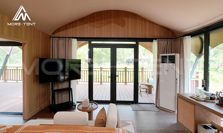 Glamping tent living area with climate control and deck access