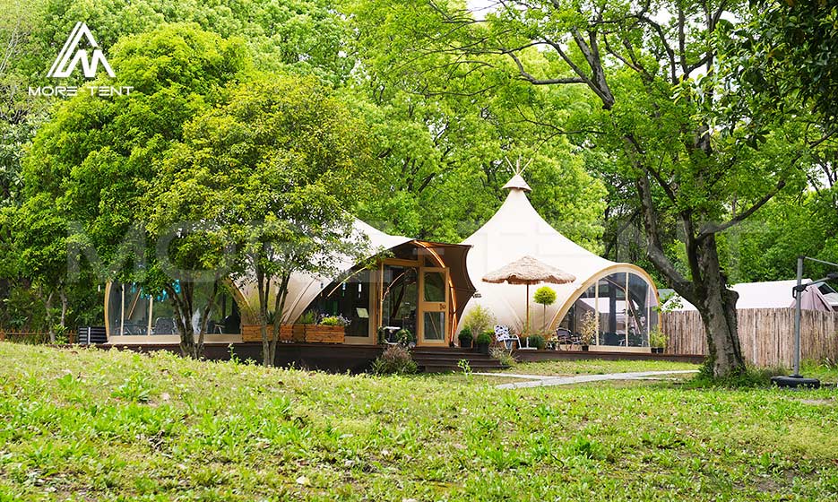 Safari glamping tents integrated into a mature forest resort