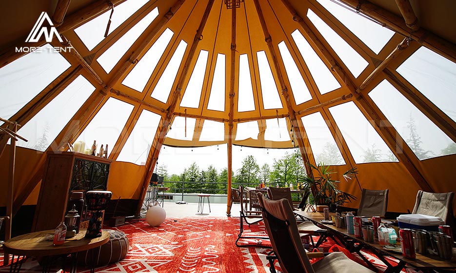 Spacious glamping tent lounge beneath a timber-framed roof