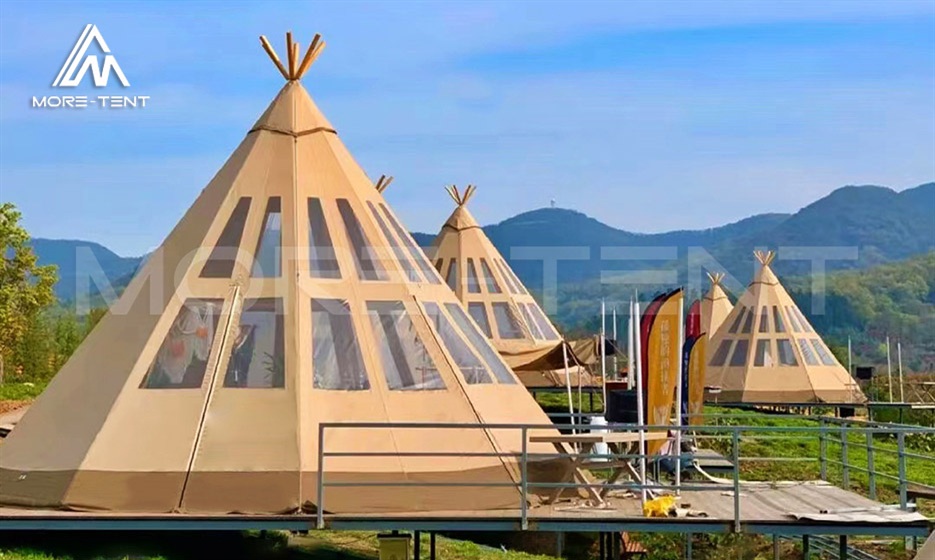 Tipi glamping tents arranged across a mountain resort