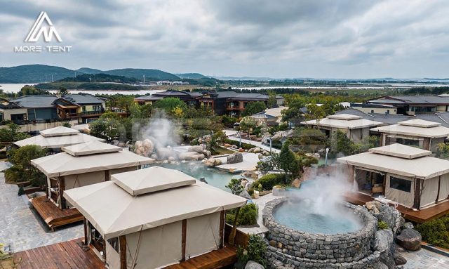 Elevated view of modular glamping tents across a hot spring resort