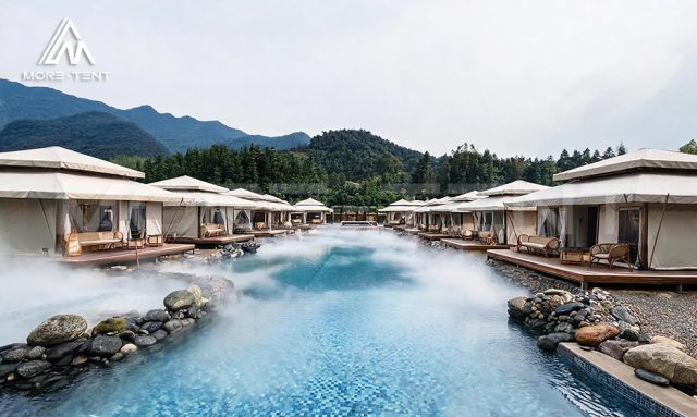 Pattaya glamping tents facing a wide blue hot spring pool